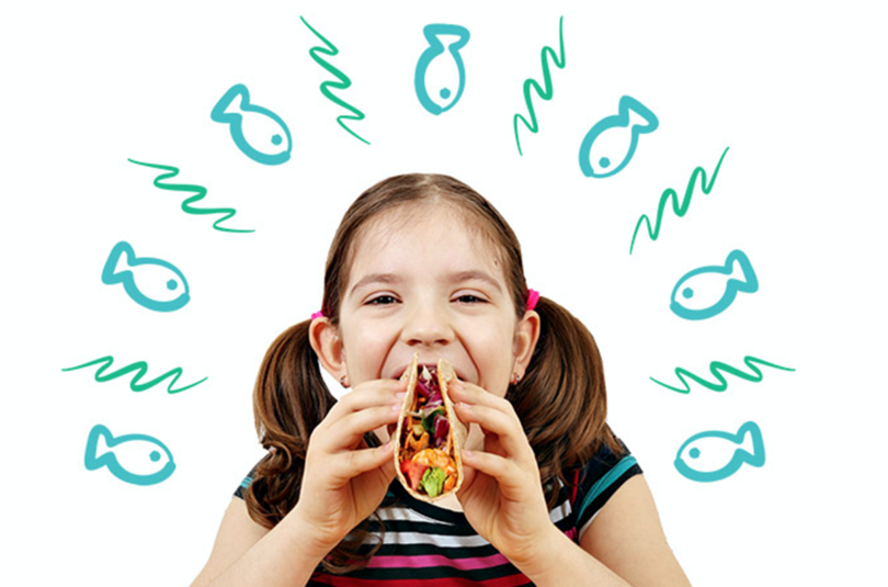 girl eating fish taco for benefits of seafood