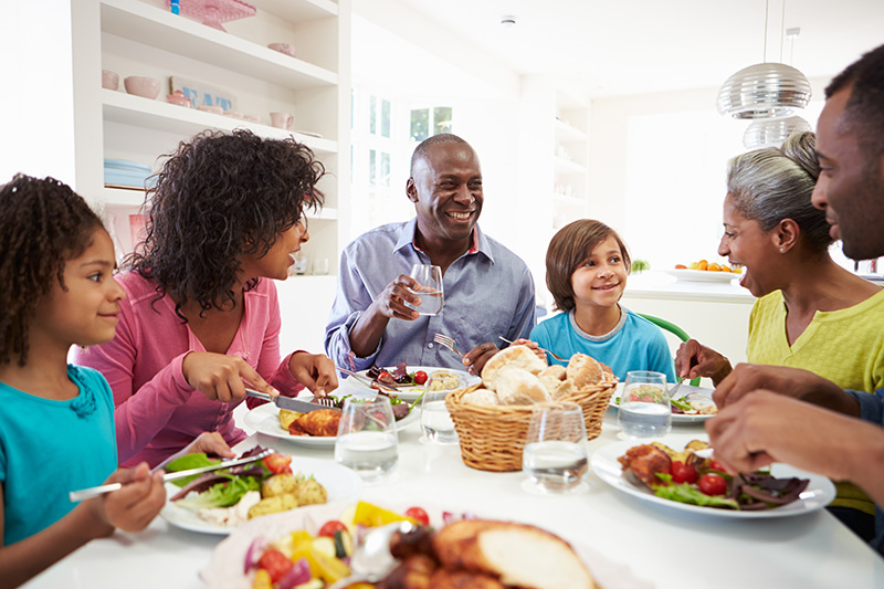 Stock image of a family eating dinner together