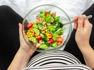 Can you eat fish during pregnancy? Eat Seafood While Pregnant: Picture depicts woman eating tuna salad while pregnant