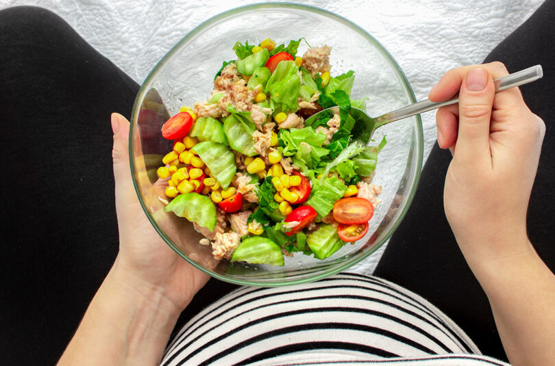 Can you eat fish during pregnancy? Eat Seafood While Pregnant: Picture depicts woman eating tuna salad while pregnant