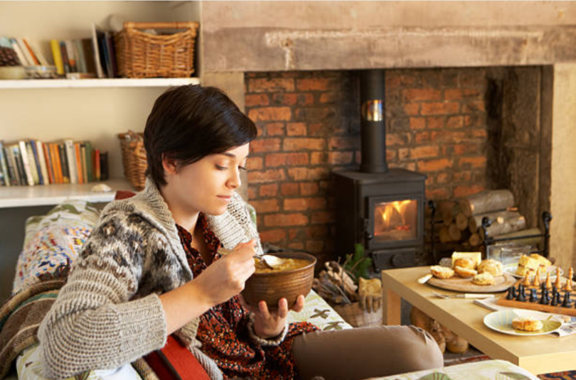 Eating seafood chowder by the fireplace