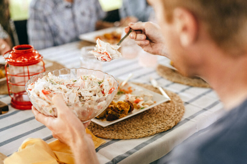 seafood is important for men's health. Man eating surimi salad.